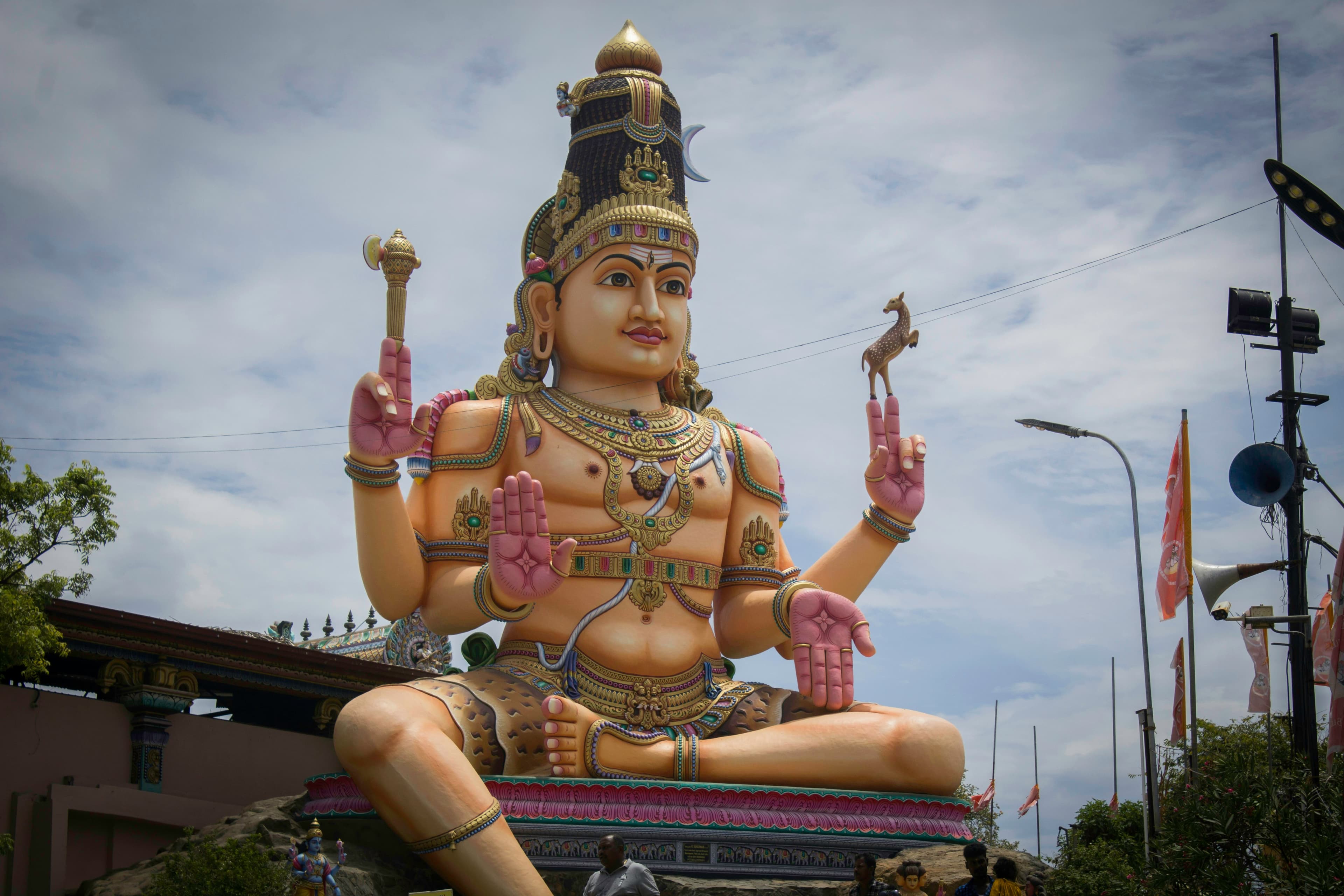 A Buddha statue near a white building in Trincomalee