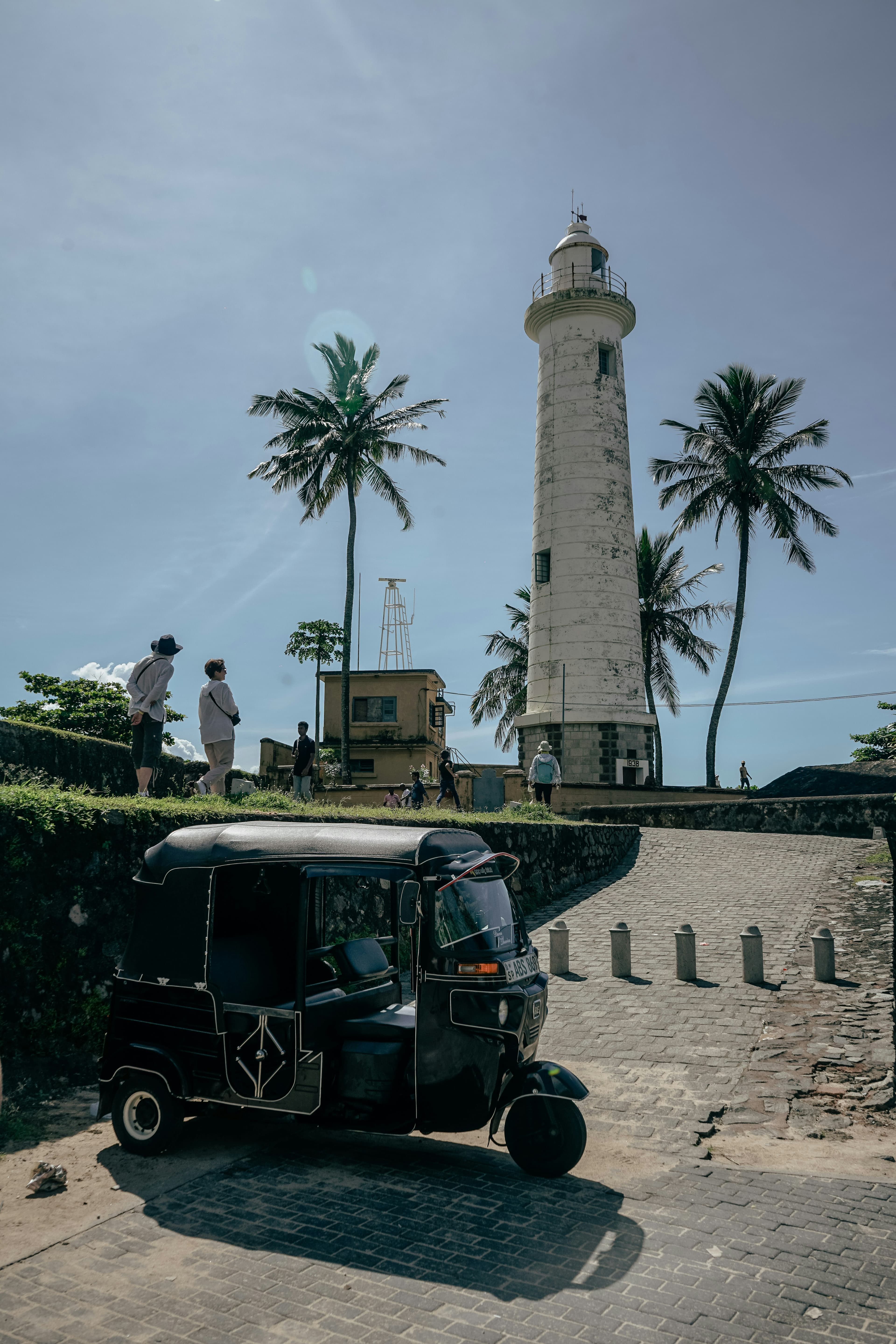 A tuk tuk parked in front of the lighthouse at Galle